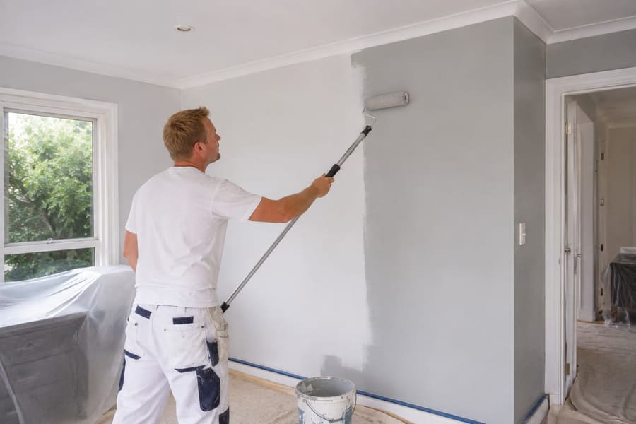 Painter rolling a fresh coat onto an interior wall